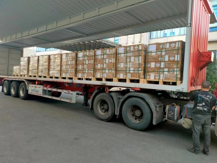 containers of lithium cells loaded on to trucks for export after receiving millions of pre-payment
